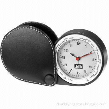 Travel alarm clock, made of Zn-Al alloy + PU, measures 65x60x27mm